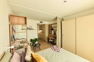a bedroom with a bed and a living room at Be Casa Sant Cugat in Sant Cugat del Vallès
