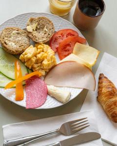 a plate of food with bread and vegetables on a table at Villa Brunnby in Mölle