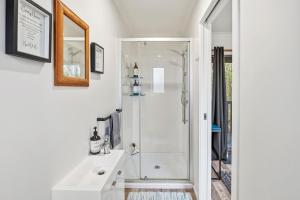 a white bathroom with a shower and a sink at Country Nirvana in Pataua +47 photos