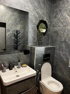 a bathroom with a white toilet and a sink at SoTA SKI in Pilipets +98 photos