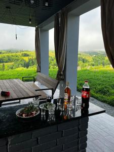 a bar with drinks and a plate of food on it at SoTA SKI in Pilipets