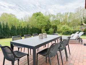 a black table and chairs on a patio at Seebär in Scharbeutz