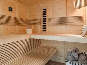 a sauna with wooden walls and wooden shelves at Seebär in Scharbeutz