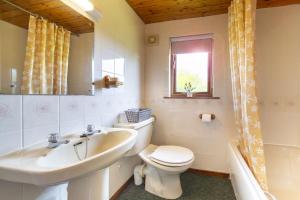 a bathroom with a toilet and a sink and a tub at L4 - Porthbeor in Truro +13 photos