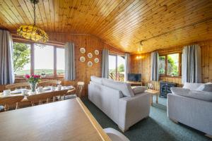 a living room with a couch and a table at L4 - Porthbeor in Truro
