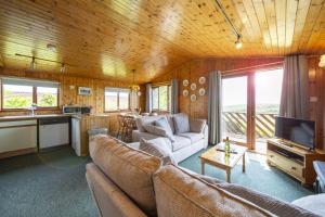 a living room with a couch and a kitchen at L4 - Porthbeor in Truro
