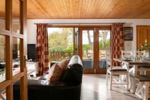 a living room with a leather couch and a table at E40 - Kiberick in Truro