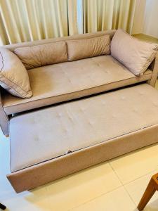 a brown couch sitting in a living room at Breezy Condo in Aonang in Ao Nang Beach