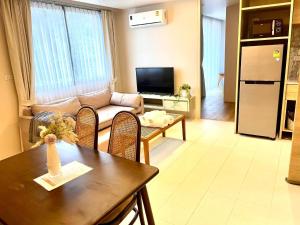 a living room with a couch and a table at Breezy Condo in Aonang in Ao Nang Beach