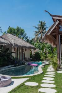 a resort with a swimming pool and a resort at Villa Nyantara - Private tropical villa in Gili Islands