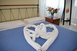 a white teddy bear laying on top of a bed at Residence Le Corniole in Arezzo