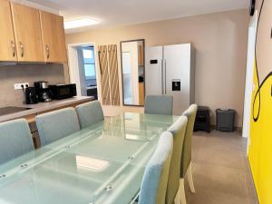 a dining room with a glass table and chairs at Apartment "Paris - Amsterdam" in Korschenbroich