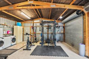 a garage with a gym with a washing machine at Country Nirvana in Pataua