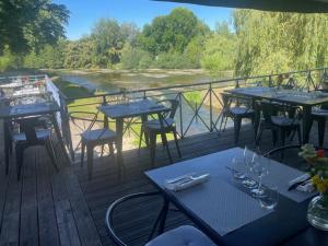 a group of tables and chairs on a deck at Hostellerie Les Griffons in Brantome en Perigord +123 photos
