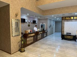 a man standing at a counter in a hotel lobby at Grand Ali'n Tokat in Tokat +48 photos
