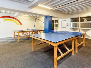 two ping pong tables in a room with a rainbow on the wall at 6 person holiday home on a holiday park in Faaborg in Faaborg