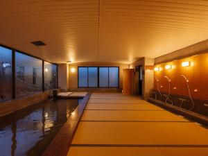 a pool in the middle of a building with lights at 汐の丸 in Imabari