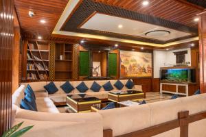 a living room with a couch and a tv at Hotel Kailash Kutee in Kathmandu