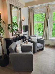 a living room with two chairs and a table at The Blue Stairs in Amsterdam