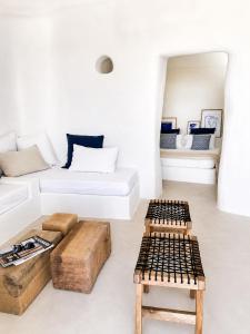 a white living room with a couch and tables at Maridea - Villa Zagara in Ponza