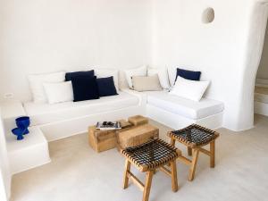 a white living room with a white couch and two tables at Maridea - Villa Zagara in Ponza +28 photos