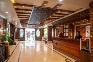 a woman standing at the counter of a restaurant at Hotel Kailash Kutee in Kathmandu