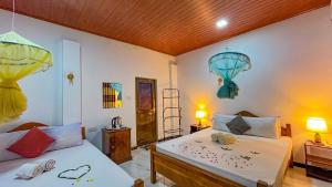 a bedroom with two beds and two lamps at Horizon Resort & Hostel Sigiriya in Sigiriya +51 photos