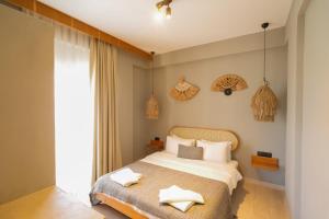 a bedroom with a bed with two towels on it at Alp Suites Mandalin in Akyaka