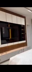 a microwave above a counter in a room at Nimpat apartment in Lagos