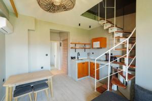 a kitchen with a staircase and a table in a room at Alp Suites Mandalin in Akyaka