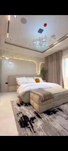 a bedroom with a large white bed and a rug at Nimpat apartment in Lagos
