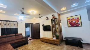a living room with a couch and a tv at Eevara Beach By Shore in Kaup +52 photos