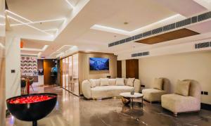 a living room with a couch and two chairs at The Prime Delhi in New Delhi
