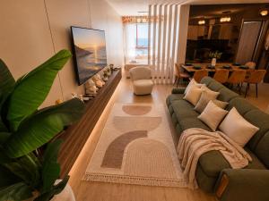a living room with a couch and a table at Beachfront Central Apartments in Durrës