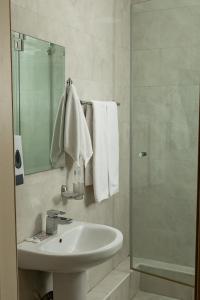 a bathroom with a sink and a shower with towels at Таугуль in Zhezdi +19 photos