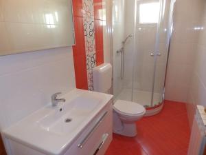 a bathroom with a sink and a shower and a toilet at Apartments Villa Jagoda in Rab +84 photos