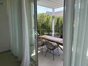 a balcony with a table and chairs and a glass door at Green Coast 60b - by Ale Investa in Palasë
