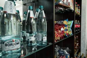 a shelf with several bottles of water on it at Таугуль in Zhezdi