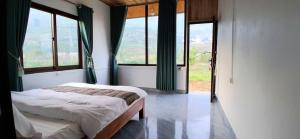 a bedroom with a bed in a room with windows at Luna Valley Homestay in Sapa +29 photos