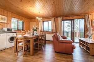 a kitchen and dining room with a table and chairs at E29 -Lawnside in Truro