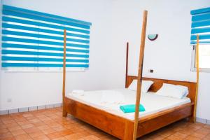 a bedroom with a bed and a window at Guesthouse Chez Marco in Cotonou +80 photos