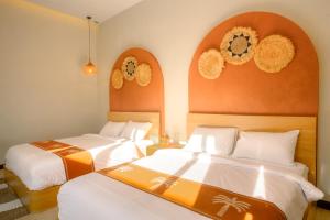 a hotel room with two beds and two mirrors at Palm Villa Prawirotaman in Timuran +10 photos