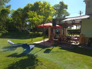 a plane sitting on the grass next to a house at Vikendica Bagremov hlad Apatin in Apatin