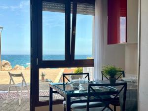 a dining room with a table and a view of the ocean at La Caseta - 5907 in Isla