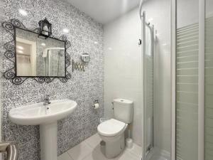 a bathroom with a toilet and a sink and a mirror at La Caseta - 5907 in Isla +6 photos