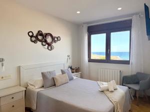 a bedroom with a bed and a window with the ocean at La Caseta - 5907 in Isla
