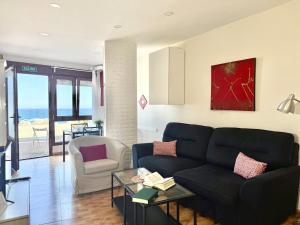 a living room with a couch and a table at La Caseta - 5907 in Isla
