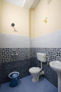 a bathroom with a toilet and a sink at Whitestone Inn in Guwahati