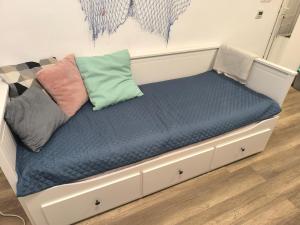 a bed with a blue mattress and pillows on it at Léda Vendégház Balatonfenyves in Balatonfenyves +103 photos
