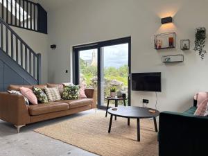 a living room with a couch and a tv at Cottage 505 - Roundstone in Roundstone
